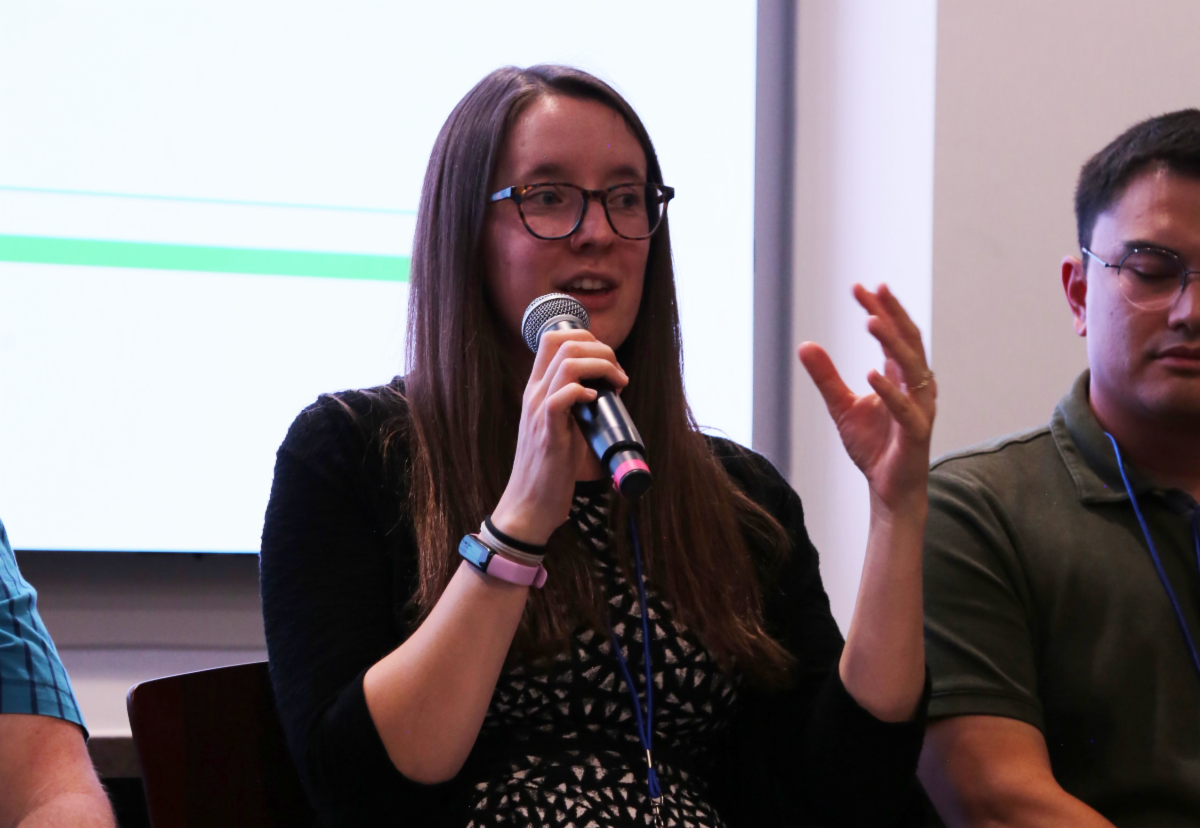 Person with microphone speaking on panel 
