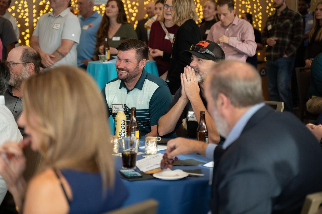 People gather at table for awards
