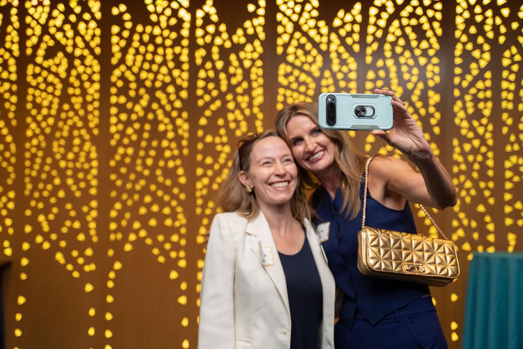 Two people smile for selfie