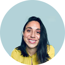 Headshot of Marisa Mendoza, a smiling woman with long dark hair wearing a yellow shirt against a light blue background.