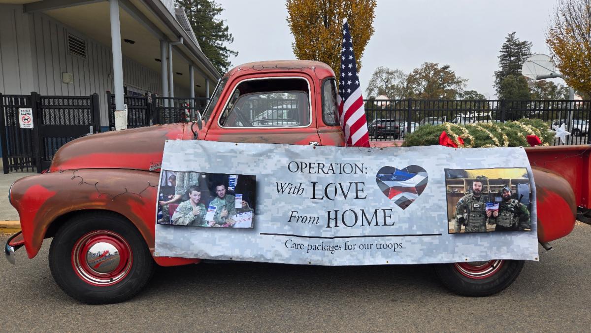 Rusty truck with a banner that reads: Operation with Love from Home
