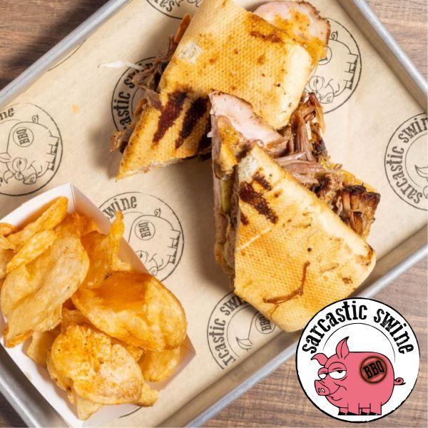 Image of Cuban sandwich House cured ham pulled pork Swiss cheese pickles golden BBQ on pressed Cubano bread side of chips