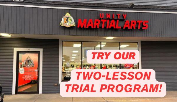 The words in red try our two lesson trial program over the background of the exterior of Unity Martial Arts studio