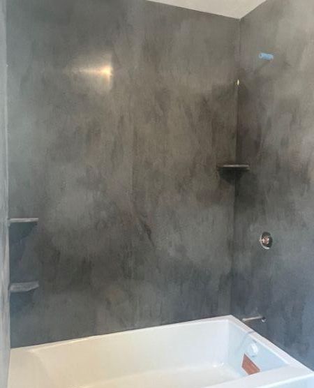 Image of a gray shower with shelves and white tub