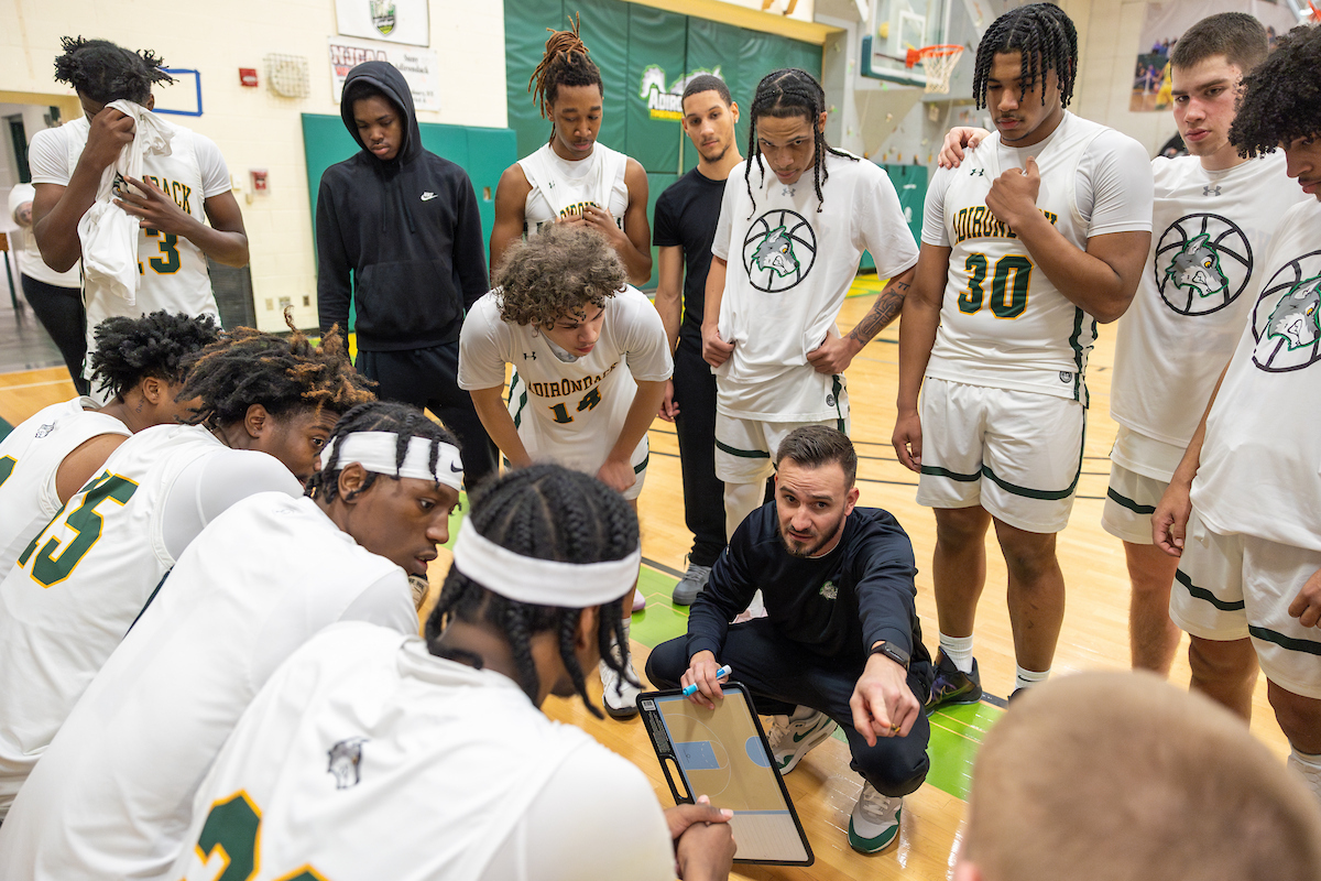 Last year's team in a huddle with the coach