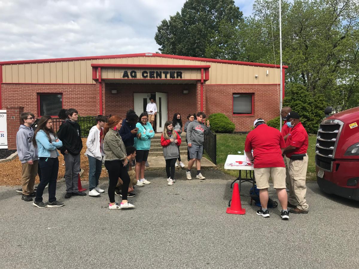 Road Team Captains John Anderson with TCW and Eddie Threlkeld with HUB Group and Kevin Davis with Ozark Motor Lines setting up presentation to students at Bradford High School