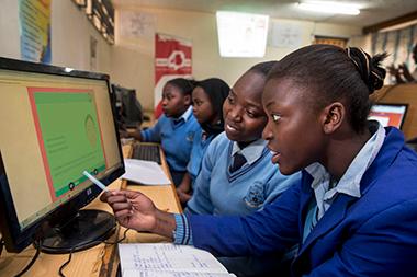 Students in Kenya working together on computers