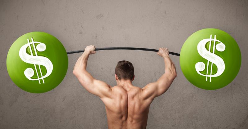 Strong muscular man lifting green dollar sign weights