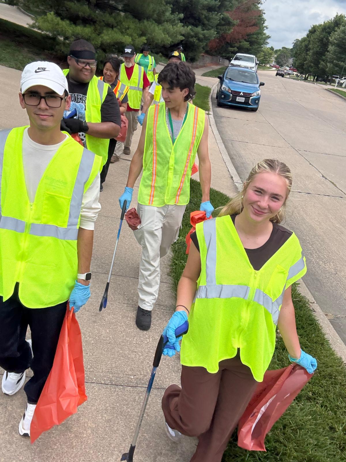 Volunteers from Schneider Electric walk to pick up litter. 