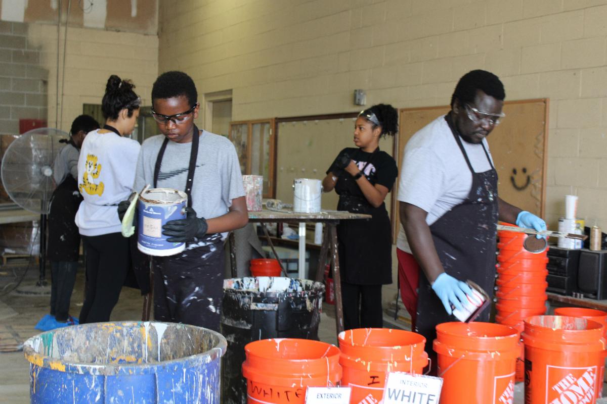 Volunteers consolidate paint to recycle at a Household Hazardous Waste collection.. 