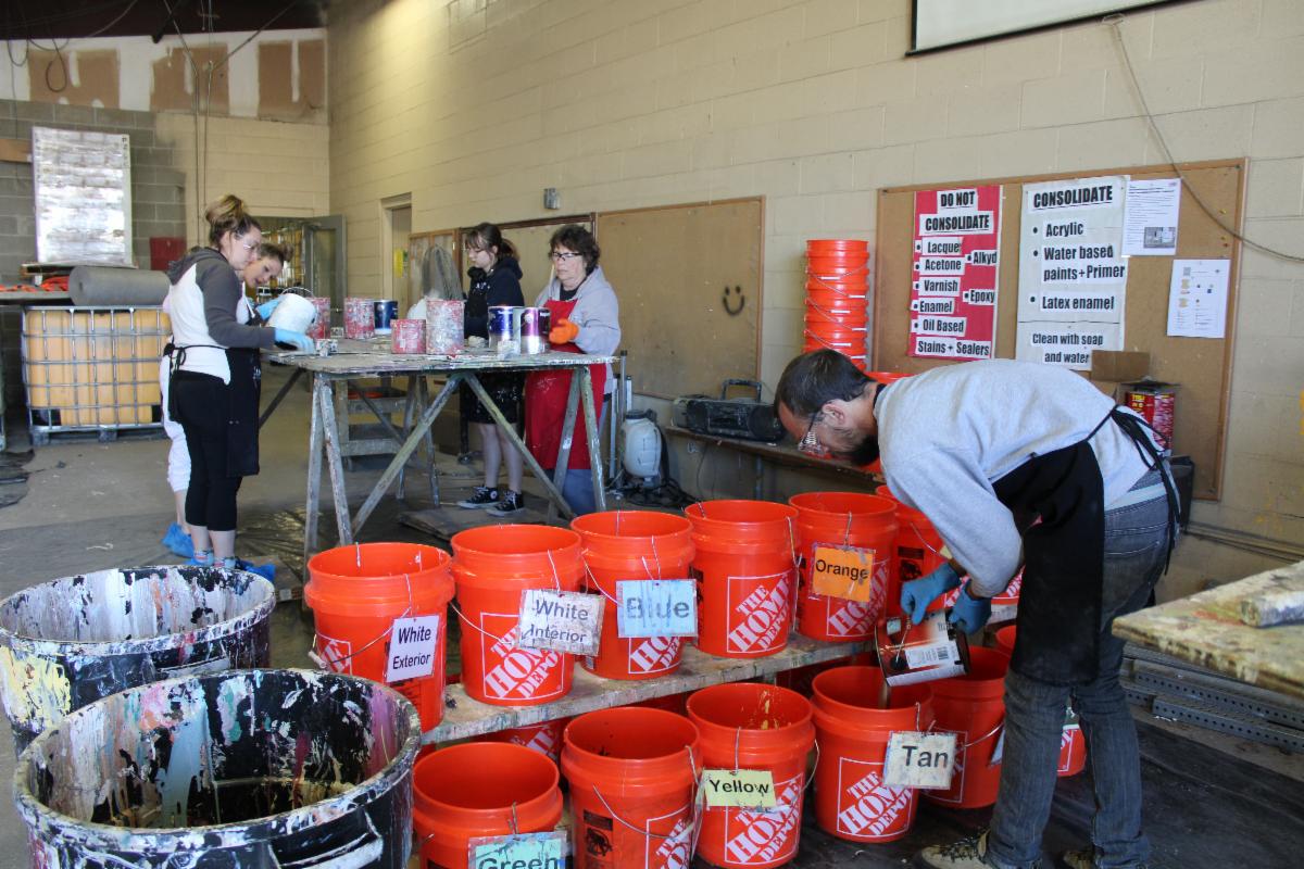 Volunteers help with Household Hazarous Waste collection by consolidating paint for reuse. 