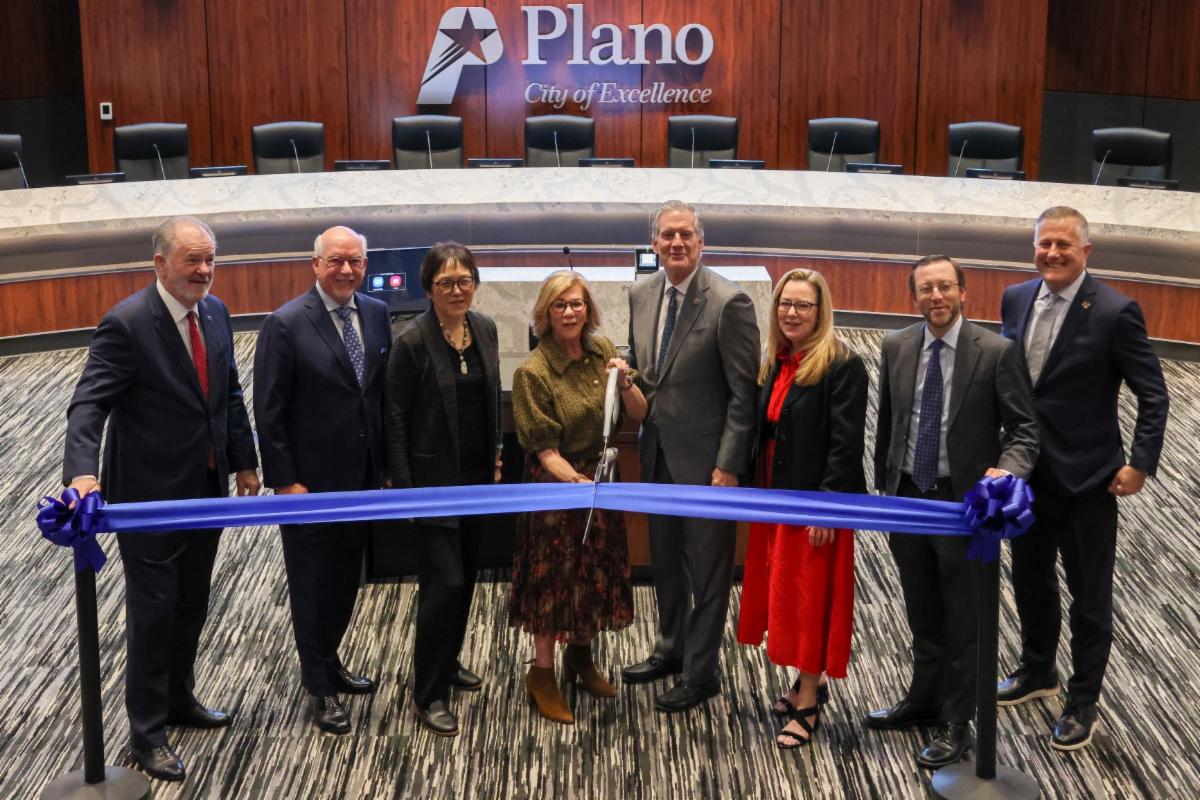 Plano City Council Sen. Florence Shapiro Mayor Muns and City Manager Mark Israelson cut a blue ribbon for the grand reopening of Plano's Council Chambers