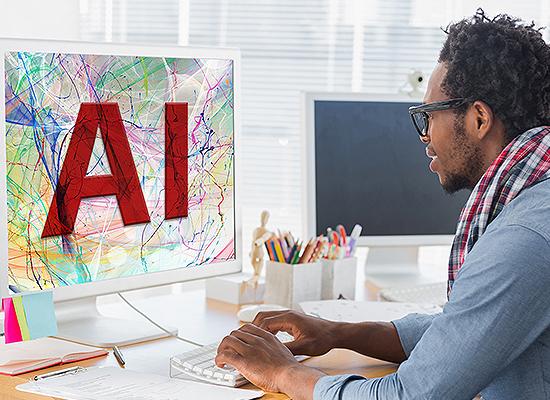 Man working at computer with A.I. on the screen