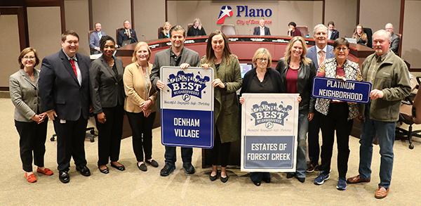 A group of residents from Denham Village and Estates of Forest Creek pose before City Council with Platinum BEST Neighborhood signs.