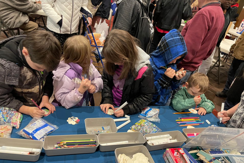 Children create winter decorations out of craft supplies.