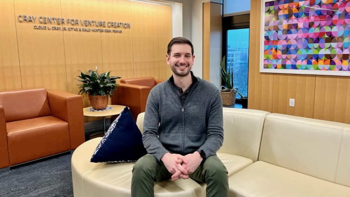 Tyler Fond sits on a couch in the Cray Center for Venture Creation.