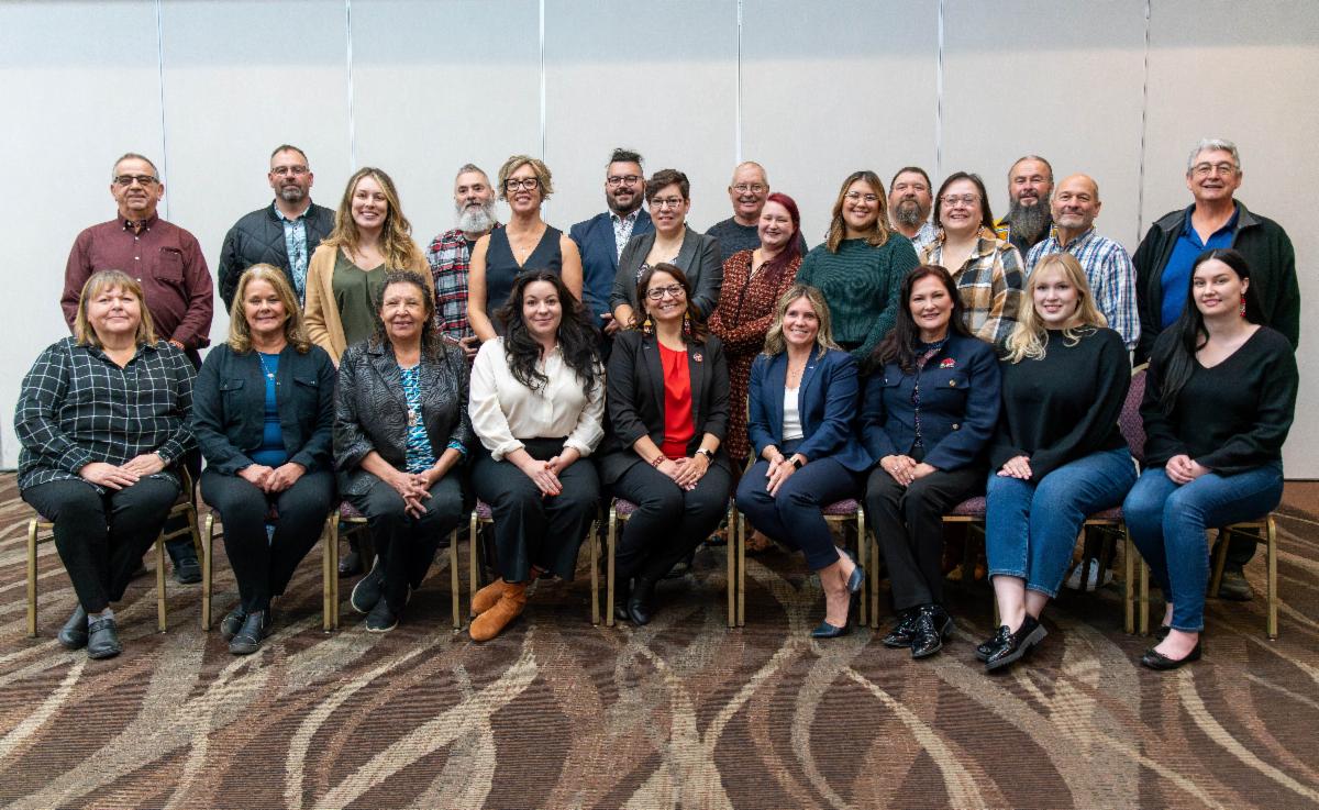 District leaders group photo, half seated, half standing, click to open link