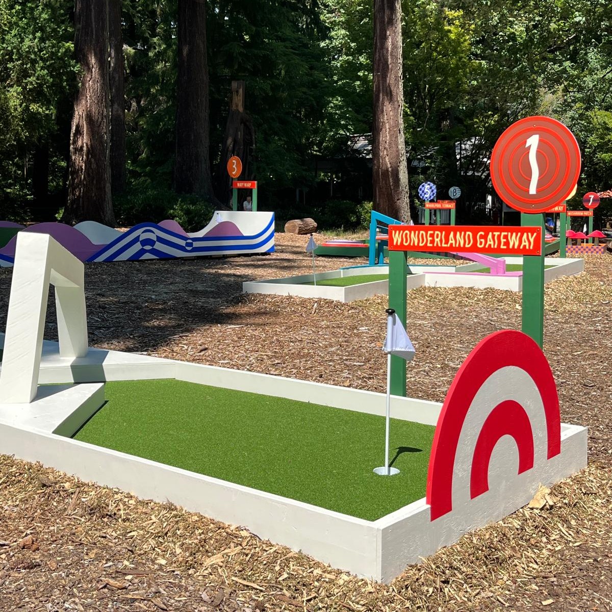 A mini golf course in a forested area