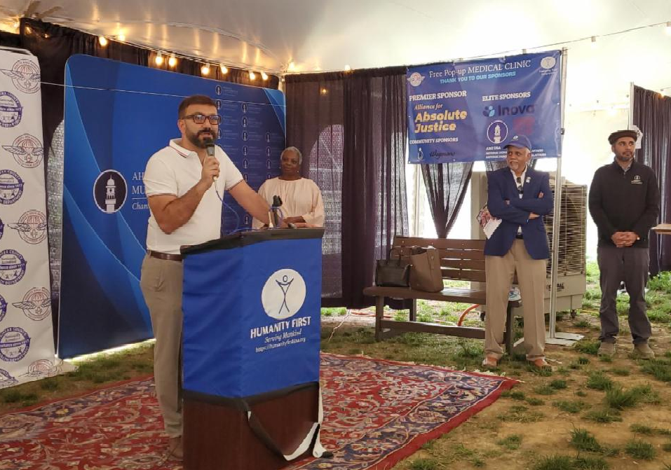 Saadat Laiq speaks at the podium.