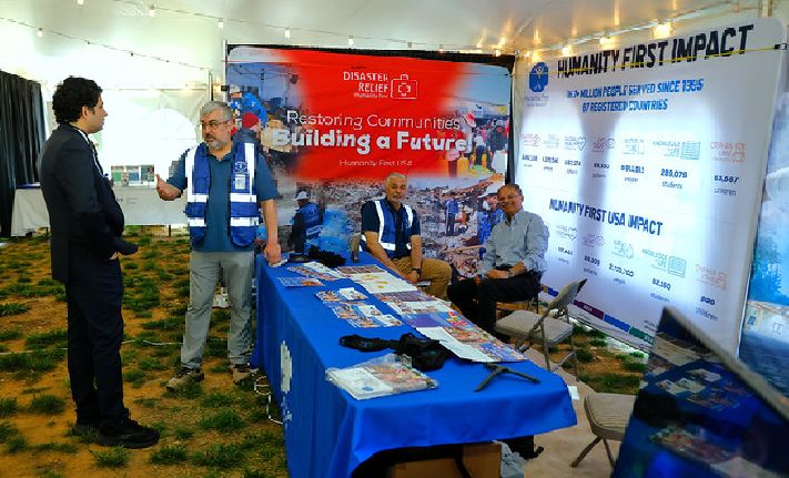 Humanity First USA VP of Programs speaks with a guest at the HF booth.