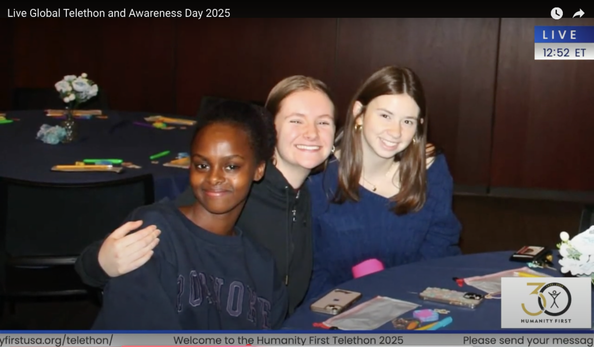 Three college aged women pose together smiling