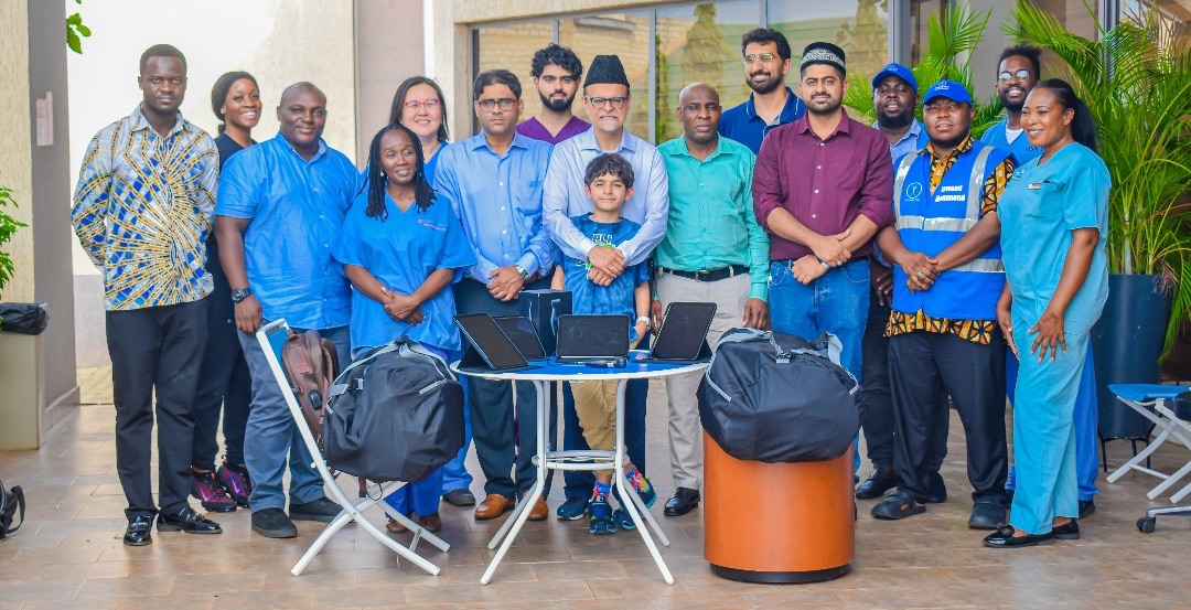 A group picture of people some of who wear blue medical scrubs.