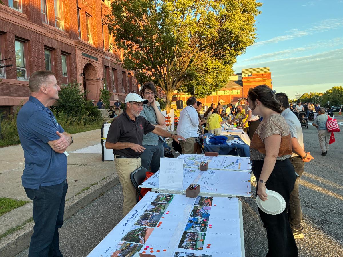 Project staff chat with residents outside on the City Hall concourse at Civic Day