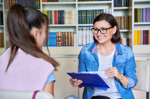 a picture of a school psycholohist talking to a student