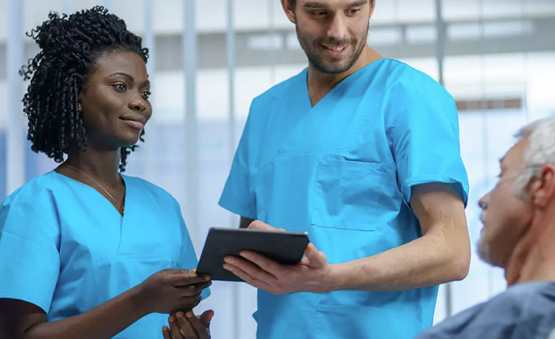an image of  medical employees talking to a patient