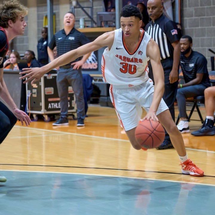 a picture of a mens basketball player dribbling a ball during a game 