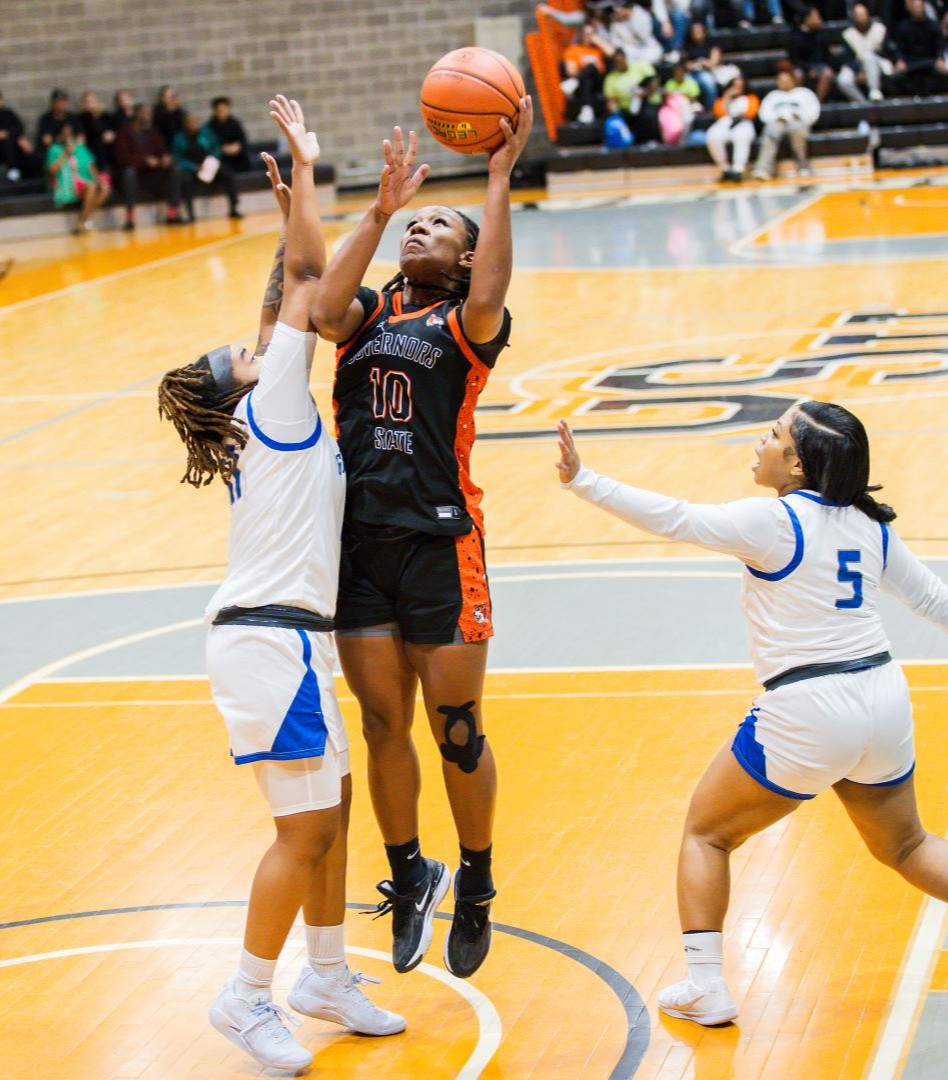 a photo of a governors state womens basketball player going up for a layup against another team