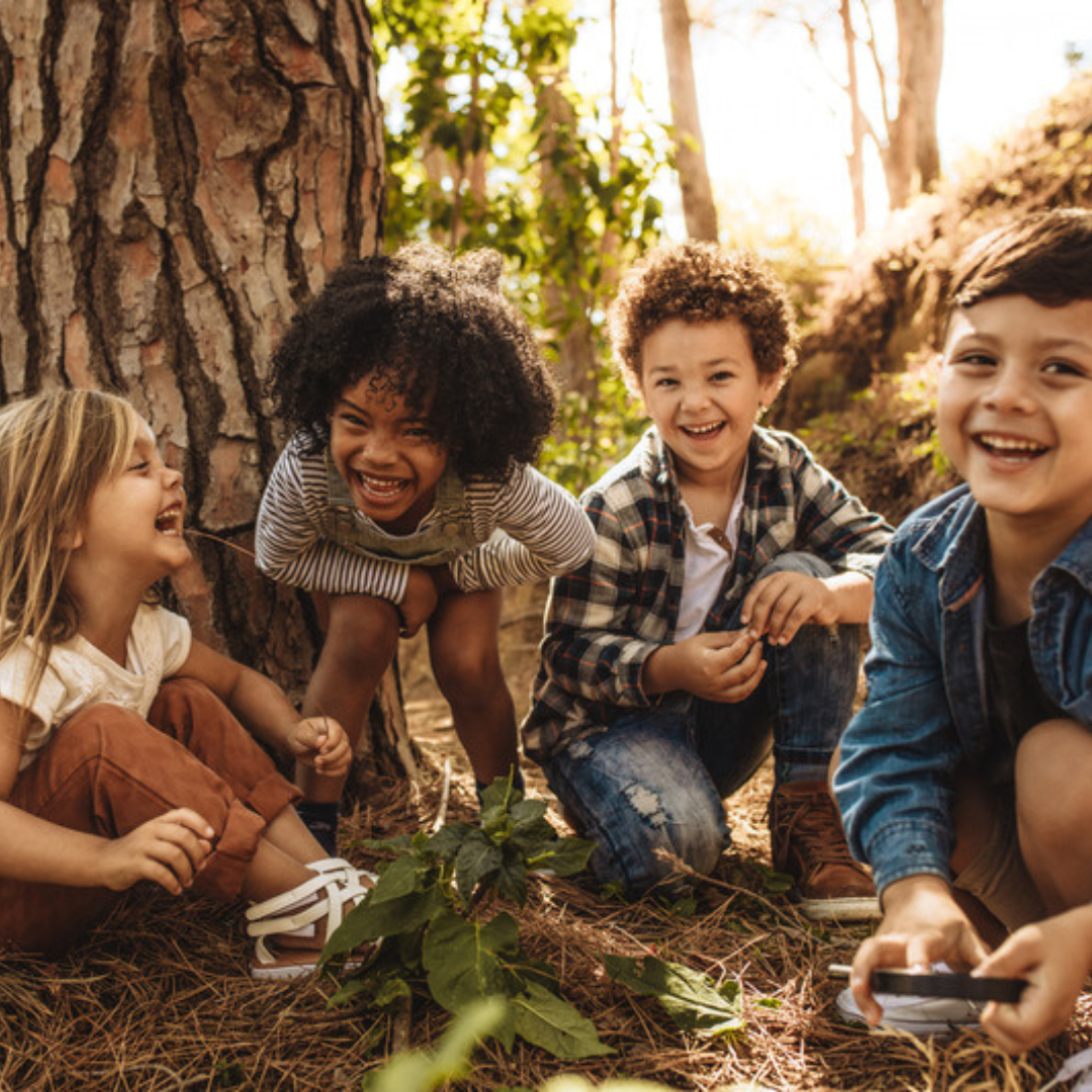 Children playing below a tree