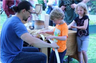 Native artist shows child bark used for traditional basket weaving