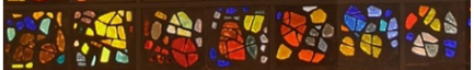 Yellow, red, orange and blue asymmetrical glass is set against a black rectangular background