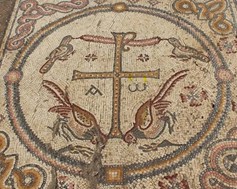 Image of a mosaic with a circle and four brown birds surrounding a stylized cross