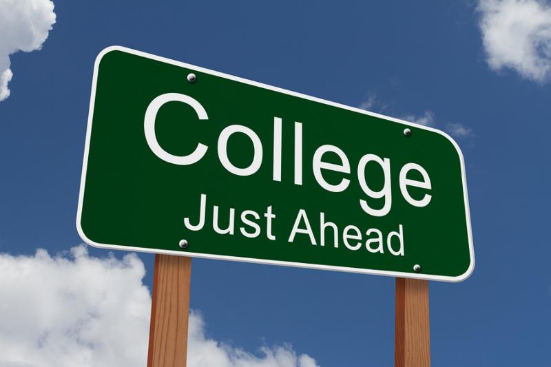 College Just Ahead Sign Green highway sign with words College Just Ahead with sky background