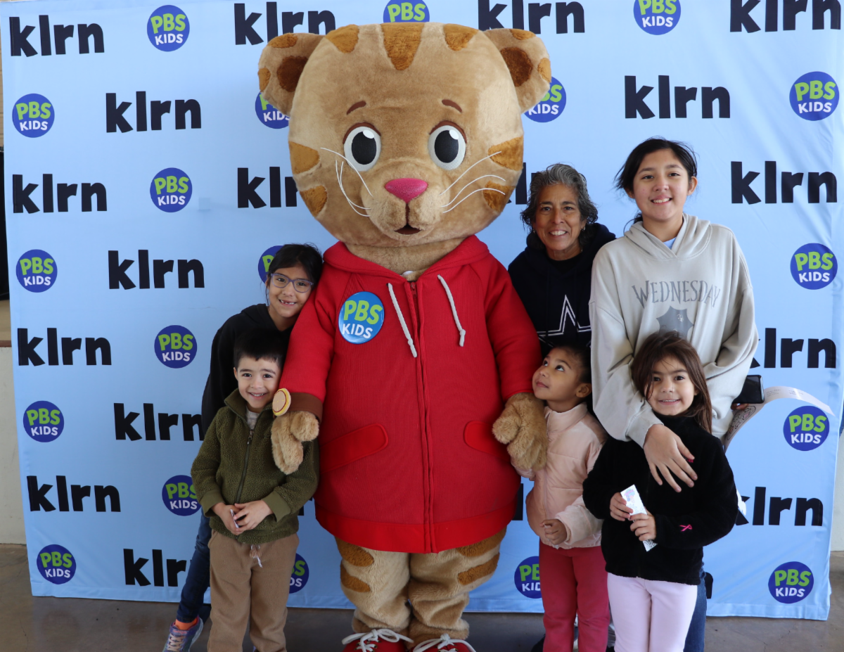 Daniel Tiger with a happy Mother and her Children