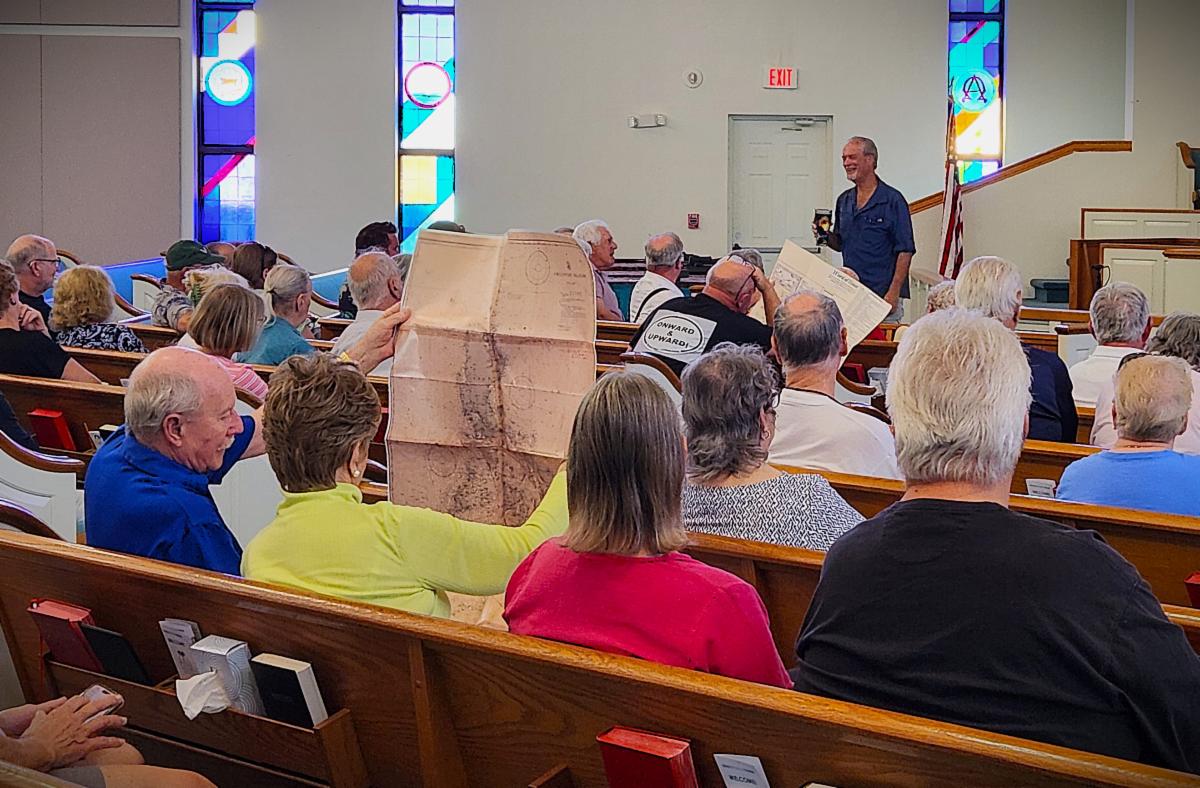 Author and lecturer Robert N. Macomber speaks about the story behind FULL NAVAL HONORS for a Meet The Author event for the Friends of the Pine Island Library.