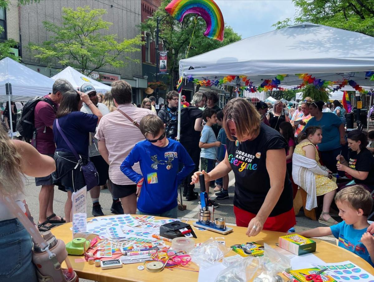Karin making buttons at SoFLX Pride