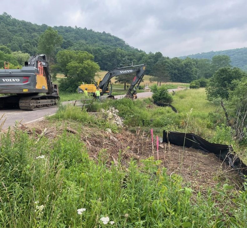 County construction workers using machinery to fix a highway in rural La Crosse County.
