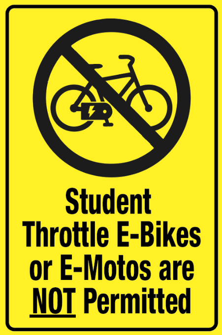 A sign placard that says "Student Throttle E-bikes or E-motos are NOT Permitted"