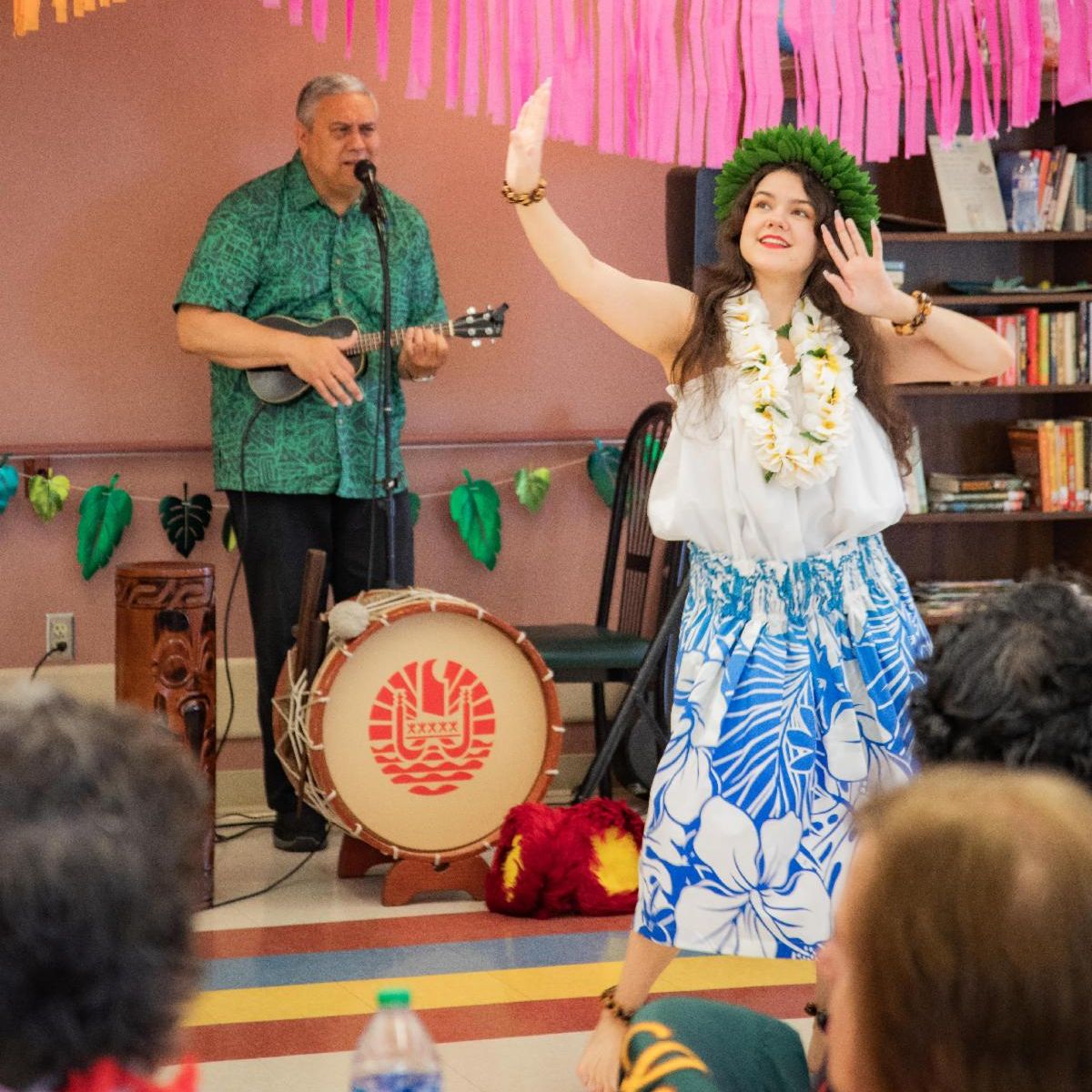 group of kuchi pudi dancers against black background looking up at blue and green sphere overhead