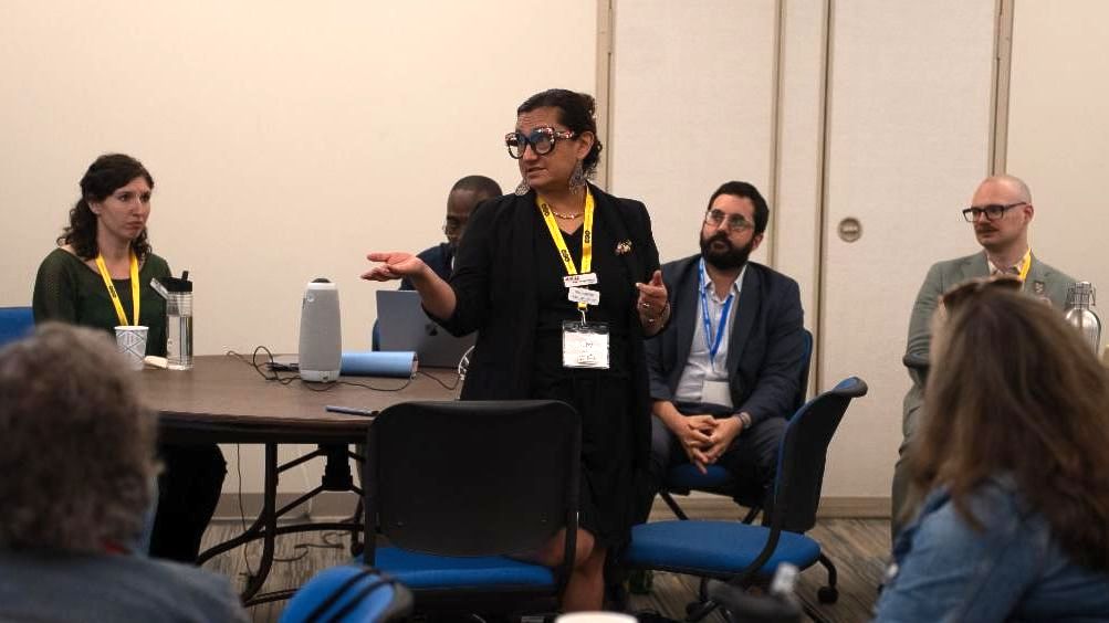 photo of msac chair ruby lopez harper speaking to audience in a classroom