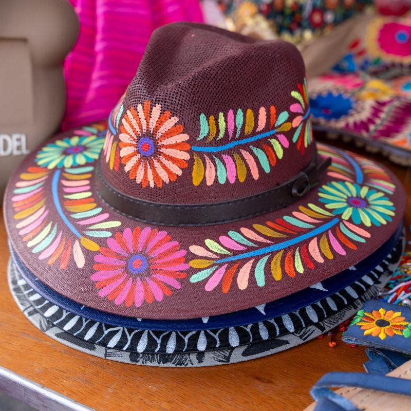 two women chatting and laughing in art gallery