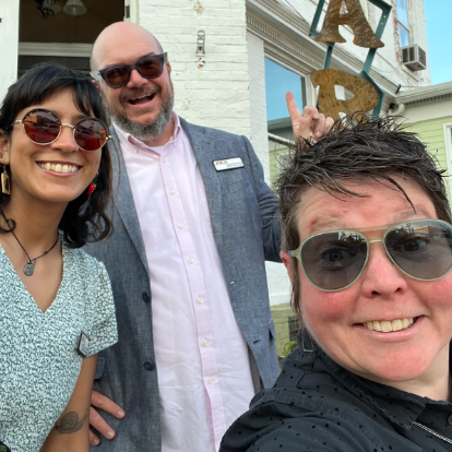 three people looking and smiling at the camera