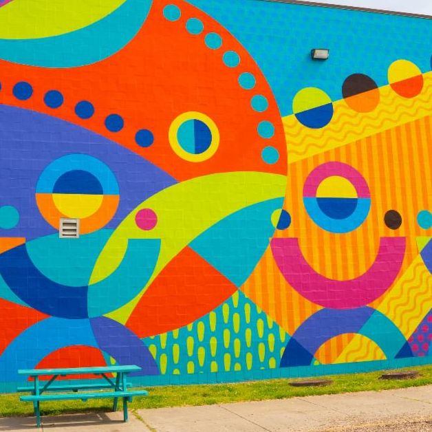 community of stars sculpture outdoors in front of coppin university college of business sign