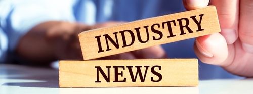 Closeup on businessman holding a wooden block with  INDUSTRY NEWS _ Business concept
