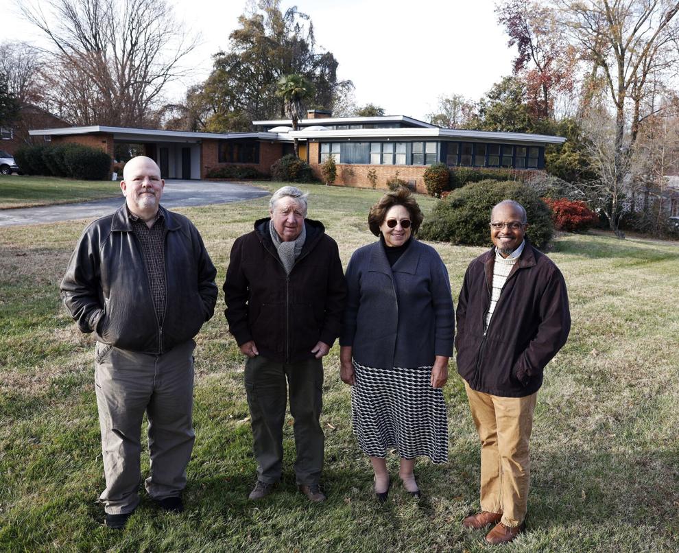 Four people standing in front of a building.