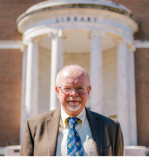 Person standing in front of a library.