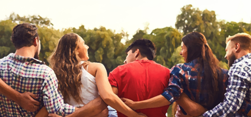 A group of young adults put their arms around each other.